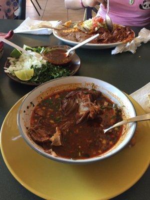 Birria with its condiments on the side