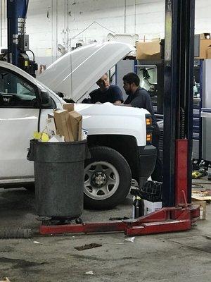 Technicians putting their heads together to figure out the problem