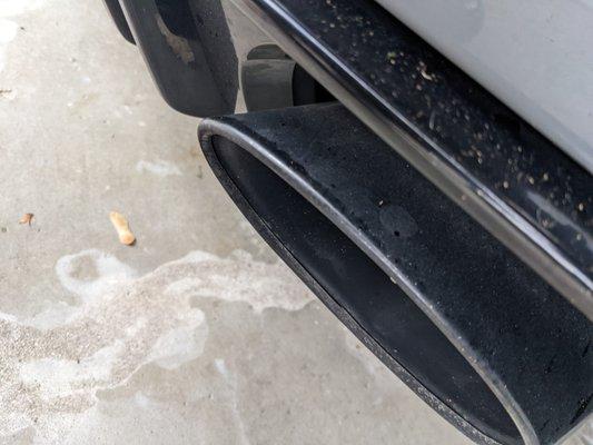 rear diffuser and exhaust tips still covered in dust and debris