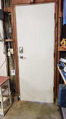 Door installed to replace old door. Solid wood masonite laminated door.