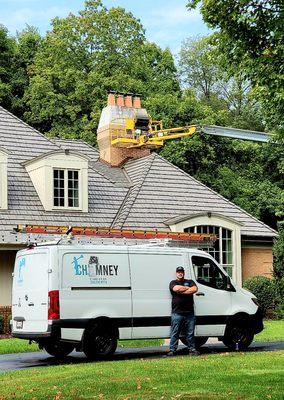 Chimney repair using an 85' Straight Boom.