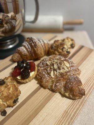 Rum almond croissant and chocolate croissant , blueberry and chocolate scones and a fruit tarte.