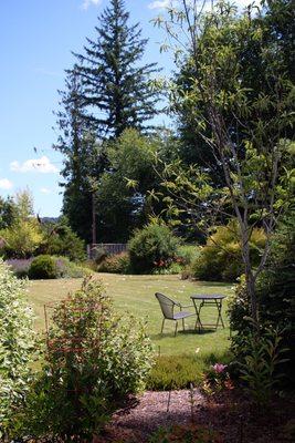 Outdoor seating in garden behind building