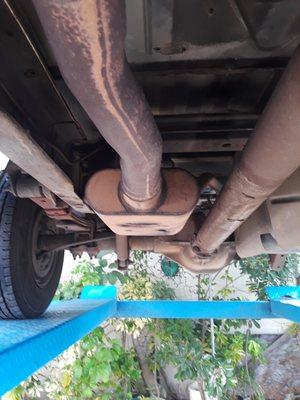 We replace "holey" rusted out mufflers like this one. We weld most joints.