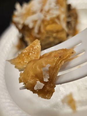 Close-up of a fork holding a piece of Baklava.