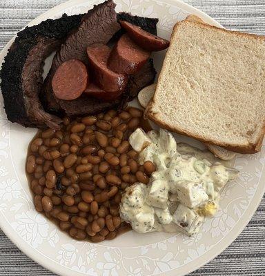 Briskets, sausage, baked beans, potato salad, and bread.