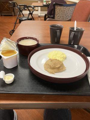 Eggs and cheese with a bread roll orange juice and hot chocolate