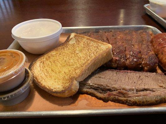 Brisket, House sausage, half rack, spicy slaw. All meats tender, flavorful, and stellar quality.