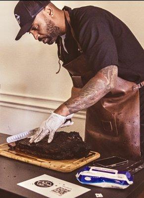 Chef mike cutting prime brisket at a catering event at cal state east bay in Hayward for 100 staff members