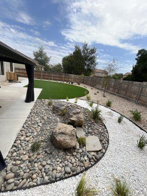 Three different types of rocks combined with an exquisite design that includes aluminum edging and synthetic grass !