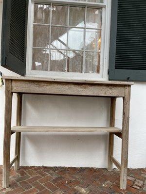 Original 200 year old cypress serving table situated outside the dining room