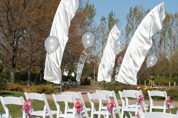 White Wood Folding Chairs and Feather Banners