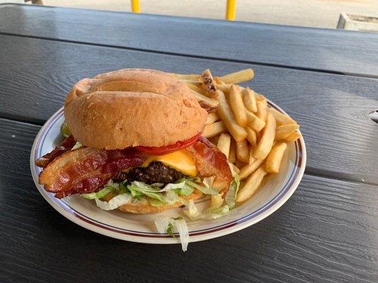 Poppy's Angus Burger with fries and pickles.