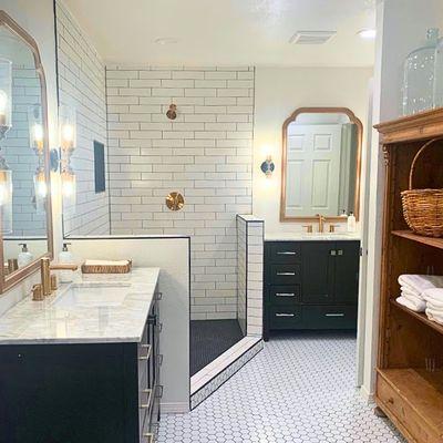 Modern designs corner bathroom. Complete with walk in shower and 2 vanities. custom wall lights and gold accents with subway tile.