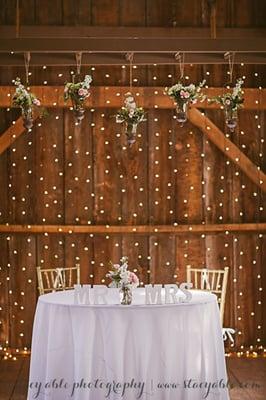 Sweetheart table inside the barn