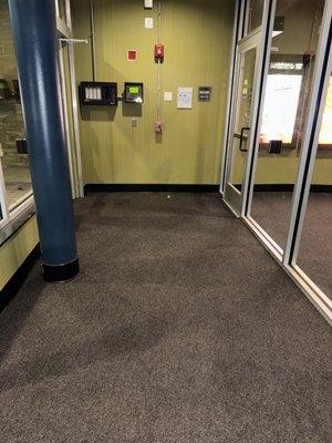 Carpet tile installation in the entrance and waiting area of a moving theater