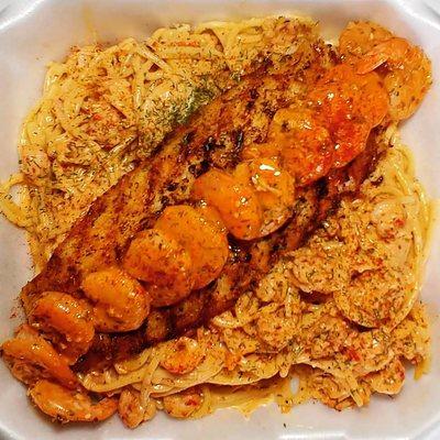 Cajun Trio! Swai fish topped with Shrimp Scampi on a bed of Crawfish Spaghetti