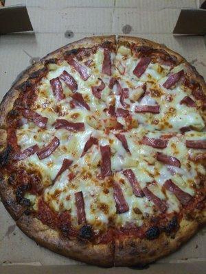 Large pizza with ham, bacon and pineapple