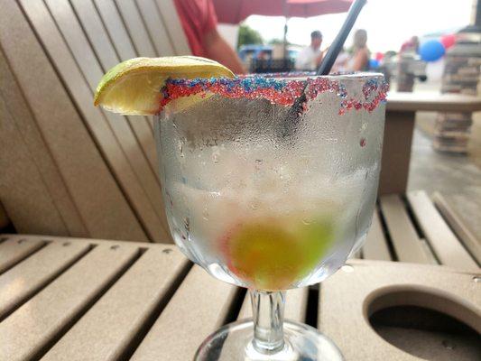 Margarita with red and blue sugar and live savor gummie 'pool rings'!