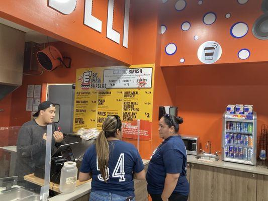 Ladies ordering burgers and the attendant