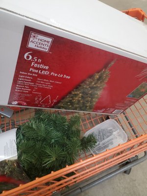 Cart filled with Christmas tree and garland plus nails for the fence