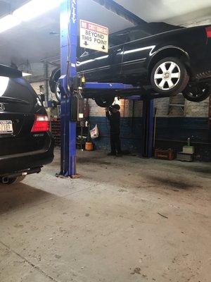 The owner, Alberto, checking my car thoroughly even though I only came for an oil change.