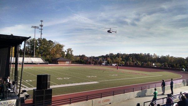 The helicopter prepares to land and pick up the Army ranger who then parachutes into the stadium.