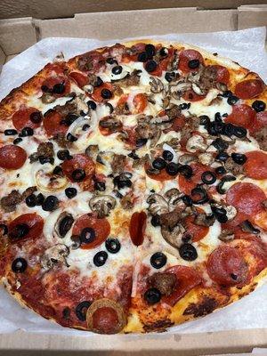 Pepperoni, sausage, mushroom, olive, and onion pizza