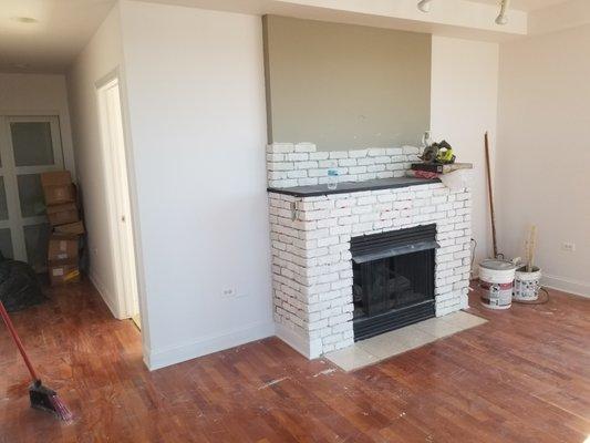 Fireplace tile was removed and replaced with a more modern brick finish.