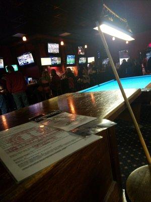 The back room has big bar and all the pool tables and more dart boards...