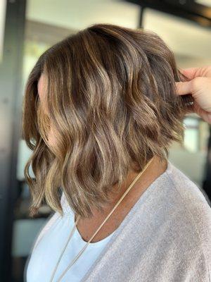 Brunette with creamy, neutral highlights with a Short, textured cut