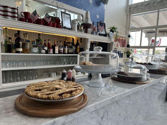 About half of the pies laid out on their counter- multiple were still warm from the oven