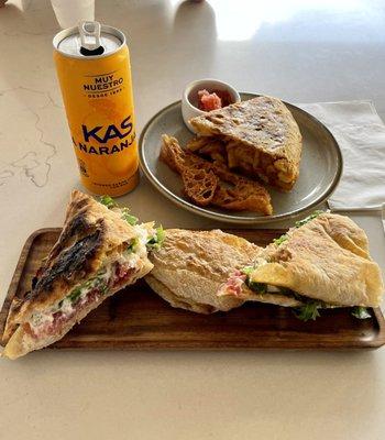 El Padrino sándwich (Jamón Iberico, stracciatella, arugula, and grated tomato), Pinchon de Tortilla aka Spanish Omelette & Kas Orange Soda.