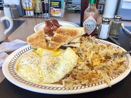 Eggs over easy, hash browns smothered, covered, chunked and diced, bacon, toast