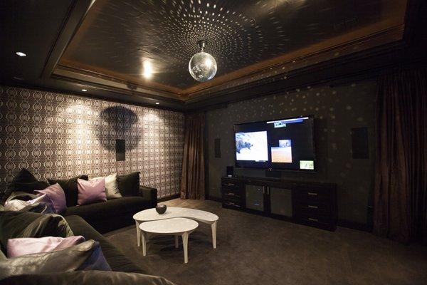 Swanky Media Room with Painted In-Wall Speakers on Wall Covering and Mirror Ball.