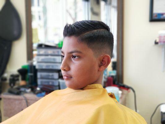 Joel at the golden sccissors getting a comb over shadow fade by his barber Edward.