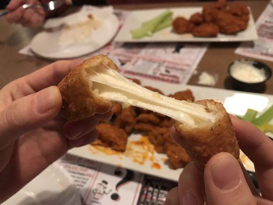 Mozzarella stick with boneless wings in background