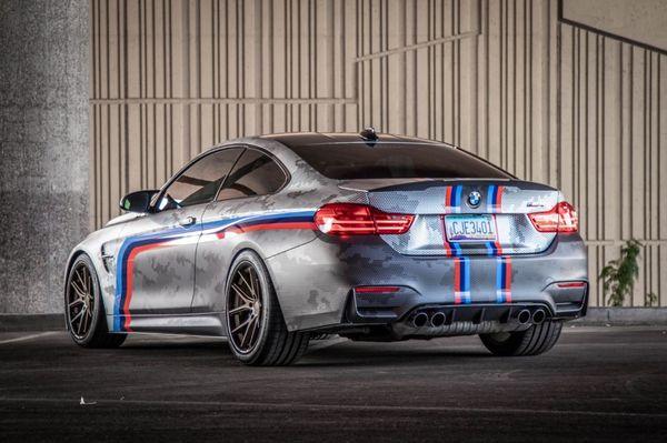 BMW M4 with custom satin wrap, stripes, and ceramic tint.