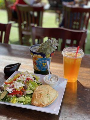 Spinach and cheese empanada with Mediterranean salad and tropical iced tea.