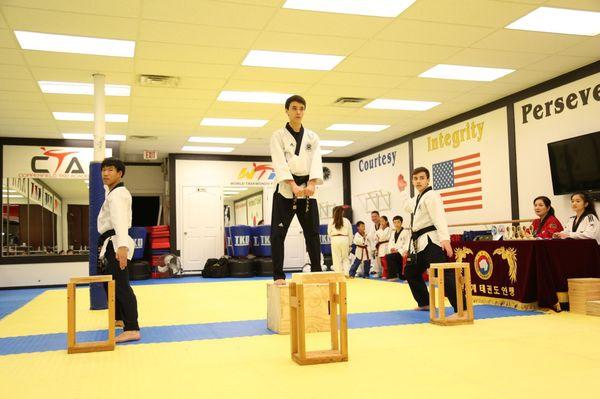 Demo Team performing a demonstration that consists of choreography+board breaking techniques at the promotion test.