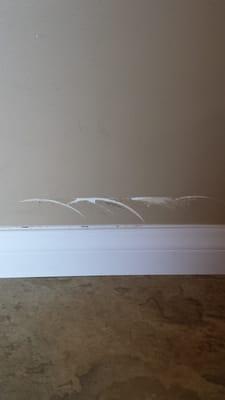 When they installed the baseboard, our wall looked like this. They didn't notify my husband what happened. He just came home and saw this.