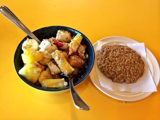 Açai bowl with pineapple strawberries honey and banana and a delicious oatmeal cookie for breakfast