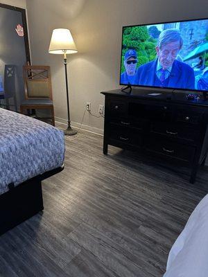 Nice clean laminate flooring with a 55 inch flatscreen TV!