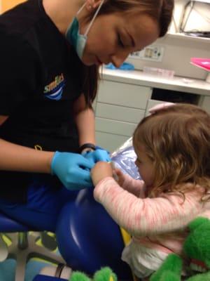 Dental staff taking her time with my daughter at her first cleaning appointment.