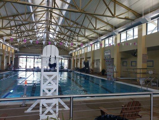 This pool has a water slide, climbing wall, diving board.