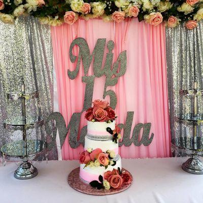 sweet 15th birthday tiered cake with fresh flowers. The walls of the cake are blended in pink. By Delicious Edibles Custom cake bakery