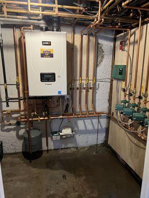 Removed a traditional boiler and water heater. Installed a new tankless high efficiency condensing combi heating system