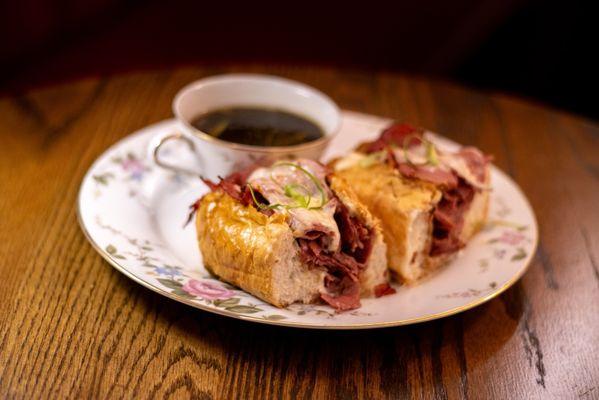 Wagyu Pastrami French Dip Toasted brioche bun, hot wagyu pastrami, provolone cheese, red wine au jus, horseradish cream