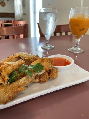 Fried chicken wings appetizer and Thai tea