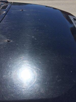 Scratched up hood with water and soap spots